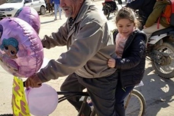 Un abuelo decoró con globos una bicicleta y fue a buscar a su nieta al colegio por su cumpleaños